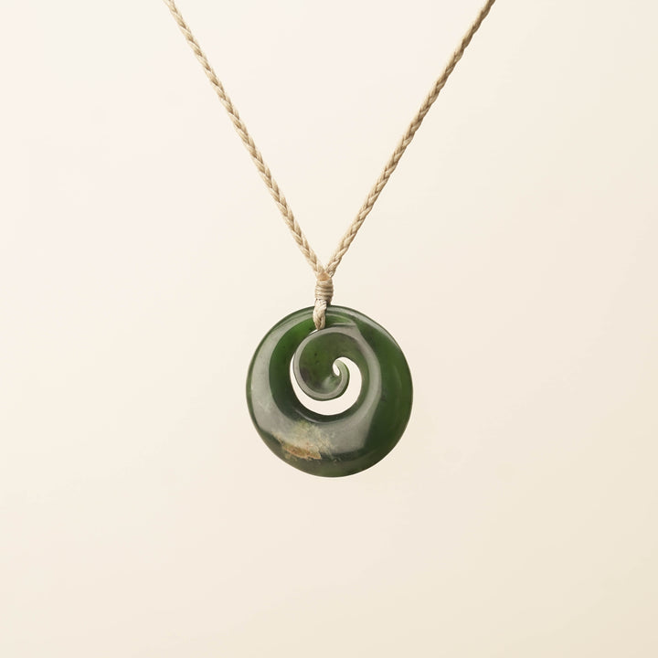 Flower Pounamu Medium Koru Pendant, Tan Binding