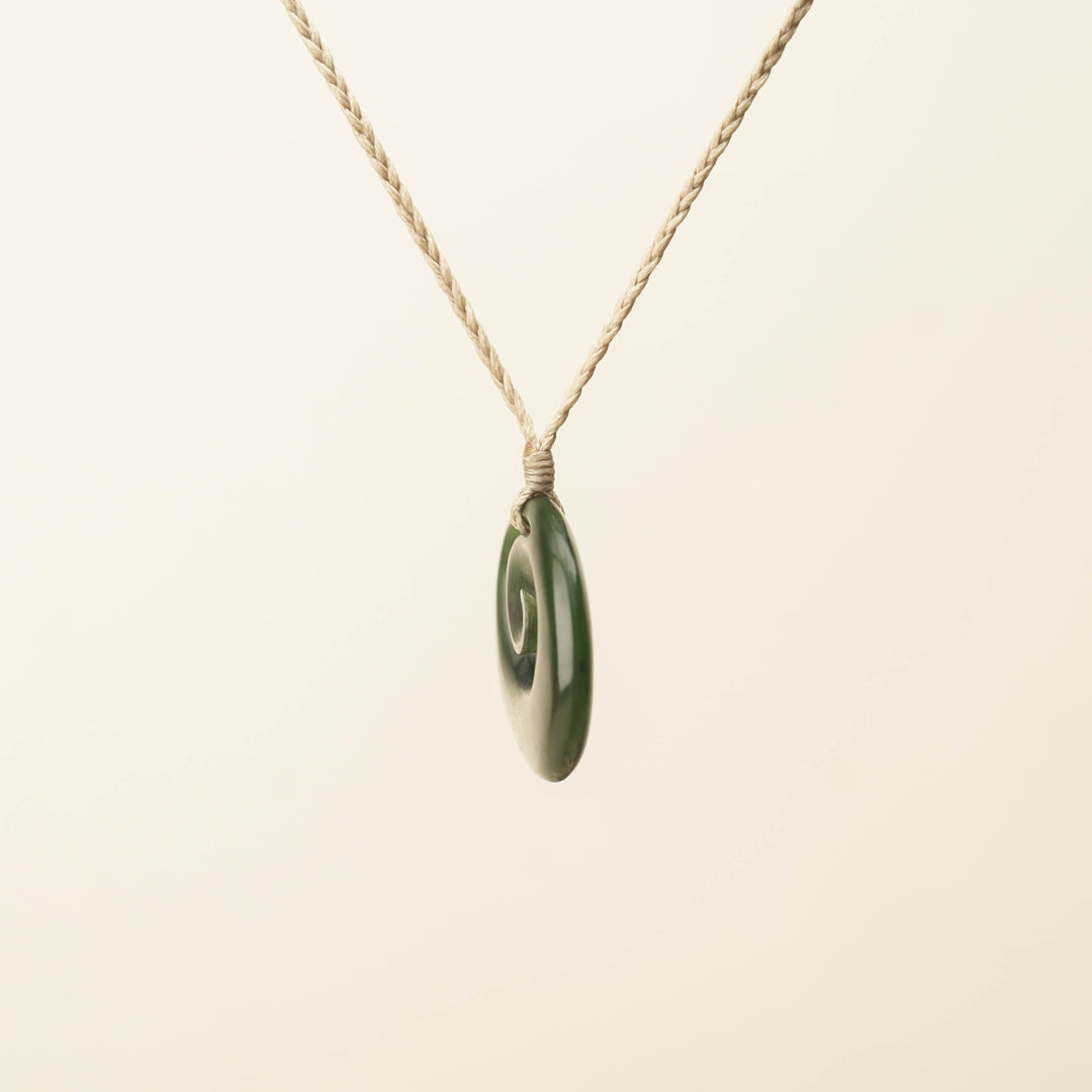 Flower Pounamu Medium Koru Pendant, Tan Binding