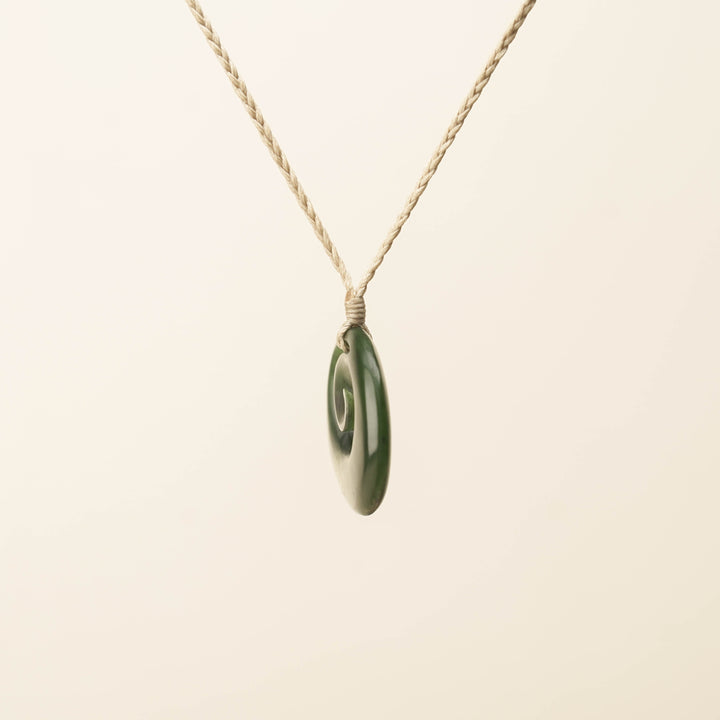 Flower Pounamu Medium Koru Pendant, Tan Binding
