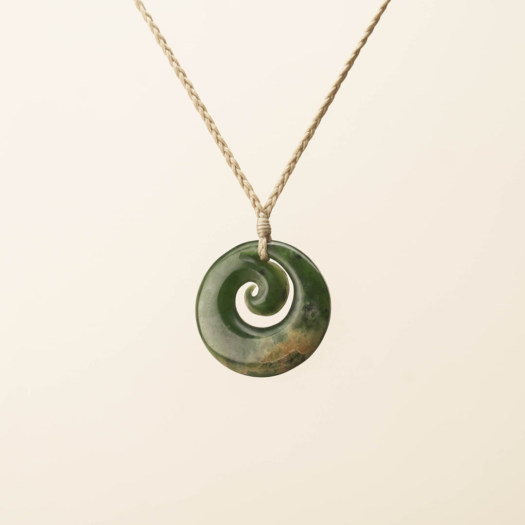 Flower Pounamu Medium Koru Pendant, Tan Binding